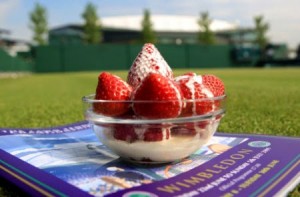 Strawberries and cream at Wimbledon with Centre Court seen in the background